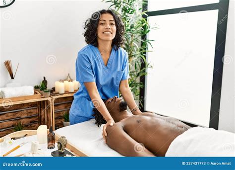 Young Physiotherapist Woman Giving Massage To African American Man At