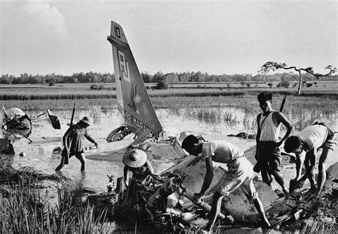 Vietcong Fighters Attend To The Wreckage Of A Downed US Plane A C Corsair II Piloted By Navy
