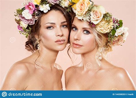 fashion models flowers hairstyle beauty two women with flower bouquet in hair stock image