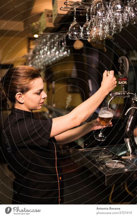Waitress Tapping Faucet Beer In Bar A Royalty Free Stock Photo From