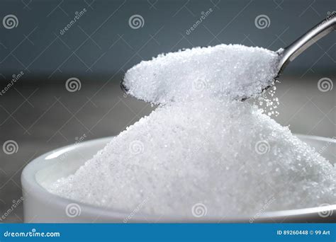 Sugar Being Poured From Spoon Into A Bowl Empty Ready For Your P Stock