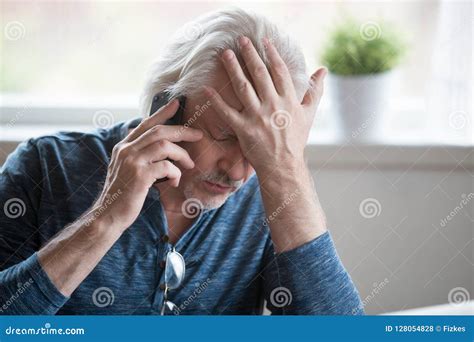 Frustrated Mature Man Feeling Upset Desperate Talking On The Pho Stock