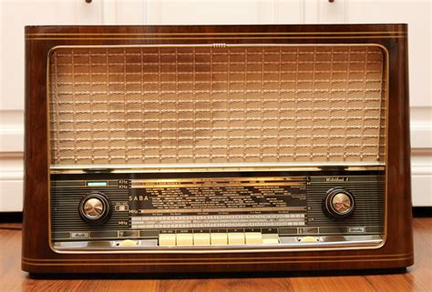 An Old Fashioned Radio Sitting On Top Of A Wooden Floor