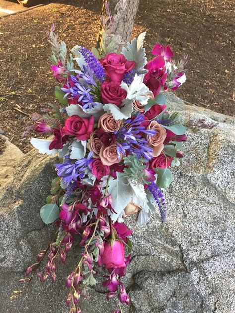 Sahara And Blueberry Roses Look Lovely In This Trailing Wedding Bouquet