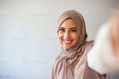 Portrait Of Young Muslim Woman Posing Taking Selfie Photo With