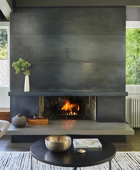 A Blackened Steel Fireplace Surround With A Concrete Hearth Is A Strong