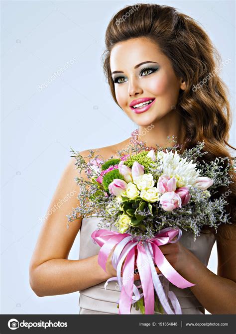 Happy Beautiful Girl With Flowers In Hands — Stock Photo © Valuavitaly