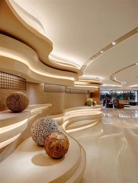 The Interior Of A Modern Hotel Lobby With Circular Seating And