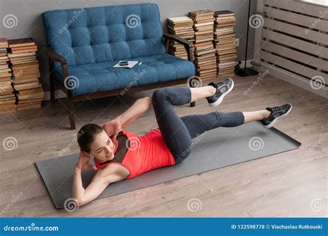Fitness Woman Doing Bicycle Crunch Exercise On Mat At Home Stock Photo
