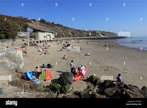 Tourists And Locals Relaxing On Sunny Sands Beach In Folkestone Kent