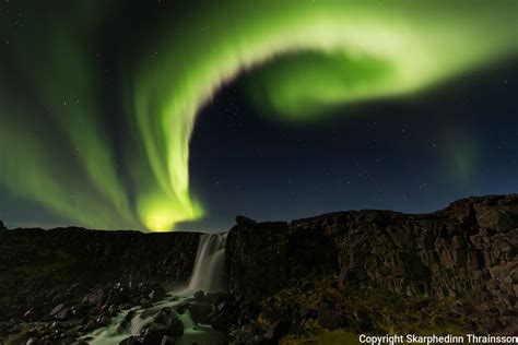 Aurora Borealis Over Öxarárfoss In Þingvellir National Park Southwest