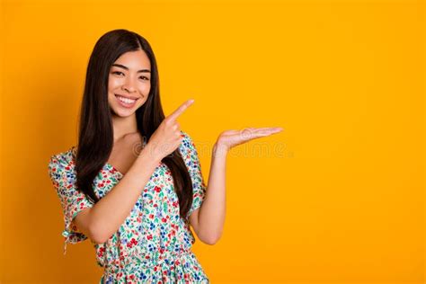 Photo Of Pretty Positive Girl Direct Finger Arm Palm Hold Empty Space