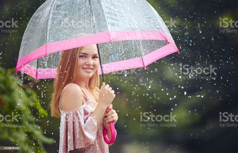 A Teenage Girl Hid From The Rain Under An Umbrella While Walking
