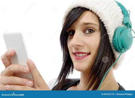 Young Brunette Listening To Music With Headphones And Phone Stock Image
