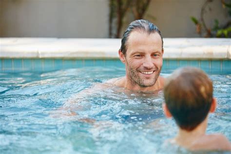 Poolside Fun A Father And Son Swimming In A Pool Together Stock Image