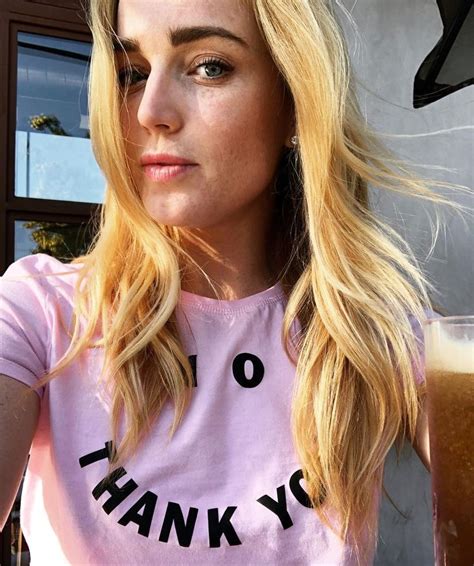 A Woman With Long Blonde Hair Wearing A Pink T Shirt That Says Thank You