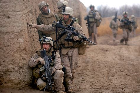 U S Marine Corps Lance Corporals Daniel Garner Kneeling And Chris Ducharme Investigate A