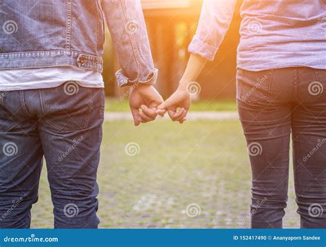 A Young Couple Holding Hands In Nature Sunrise Stock Photo Image Of