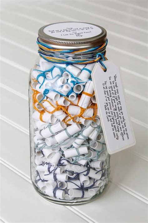 A Jar Filled With Lots Of White And Blue Spools Next To A Tag