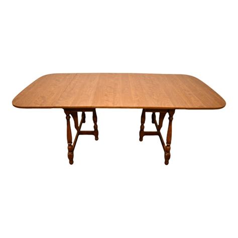 It has the bold modern geometry most often found in european contemporary design, but it is rendered in a soft natural palette of materials, solid hardwoods in low luster finishes and textured materials. Vintage Ethan Allen Heirloom Nutmeg Maple 82" Butterfly Drop-Leaf Dining Table | Chairish