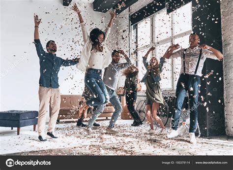 Happy Young People Having Party Home Confetti Flying Everywhere Stock