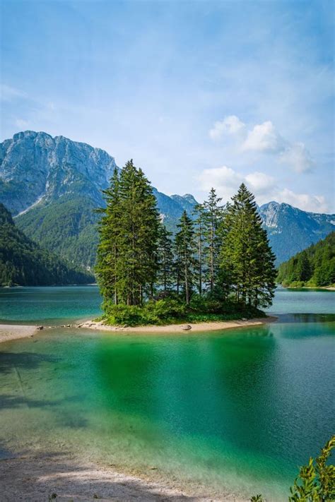Breathtaking View Of Lush Trees And Emerald Green Waters In Lago Del