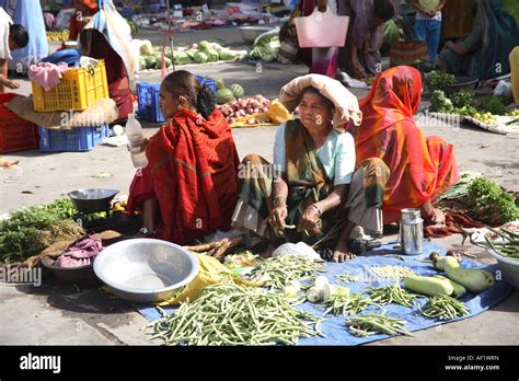 Indian Market Traders With Vegetables Laid Out On Ground In Market