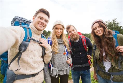 Group Of Smiling Friends With Backpacks Hiking Stock Photo By ©syda