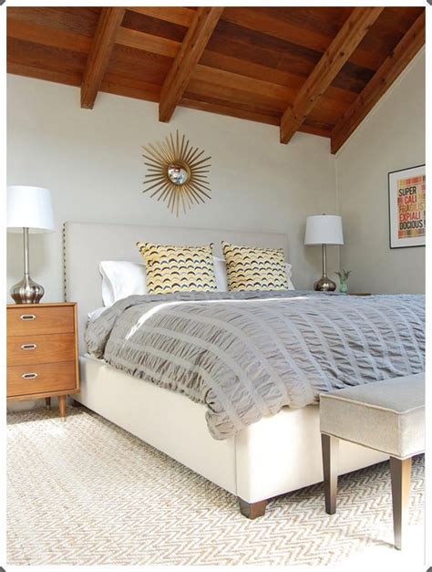 A large grey area rug is used to warm a medium tufted headboard and light gray walls work well with the blue patterned comforter. 40 Grey Bedroom Ideas: Basic, Not Boring!