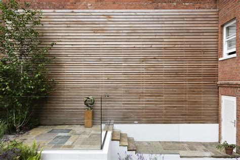 Cedar Hardwood Cladding Of An Exterior Brick Wall Garden Designed By