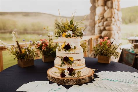 A Wyoming Wildflower Wedding At Paradise Ranch Featuring A Three Tier Naked Cake With A Mix Of
