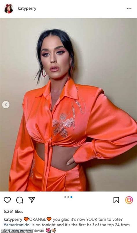 Katy Perry Flashes Her Toned Abs As She Poses In A Bright Orange Crop Top With A Matching Skirt