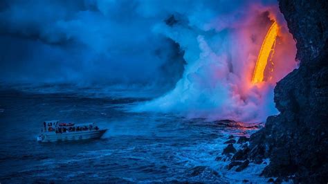 A Lava Flow Hits Water To Create An Explosion As A Tourist Boat Passes