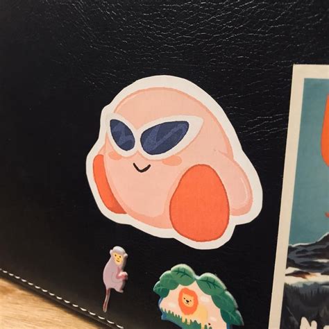 A Close Up Of A Wallet With Stickers On It