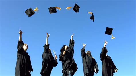 group of graduates throwing graduation caps 2493142 stock video at vecteezy