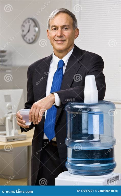businessman getting water from water cooler stock image image of food caucasian 17057321