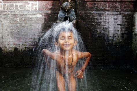A Boy Bathes In Water From A Stone Spout Near Bangalamukhi Temple In