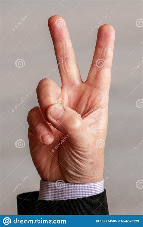 Man Gesture Shows Victory Sign Two Fingers Raised Up Stock Photo
