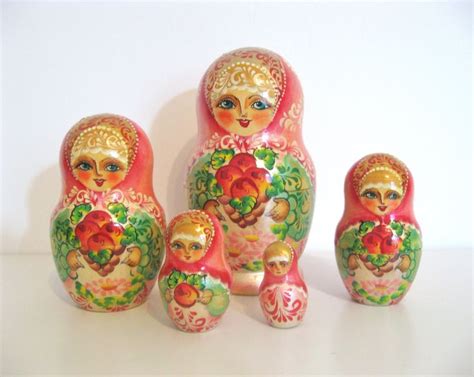 A Group Of Colorful Nesting Dolls Sitting On Top Of A White Table Next To Each Other