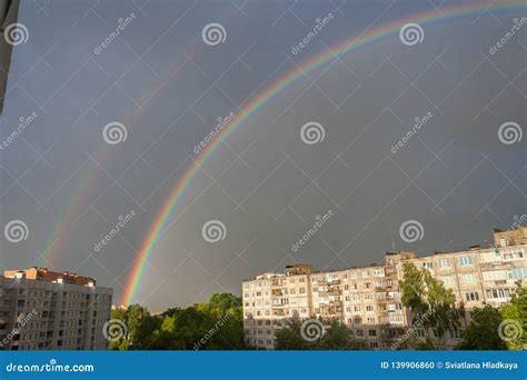 General View Of A Large Bright Double Rainbow Over The City Stock