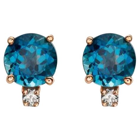 Birthstone Earrings Featuring Deep Sea Blue Topaz Nude Diamonds Set In