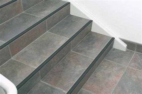 An Image Of A Stair Case Going Up To The Top Floor With Tile On It