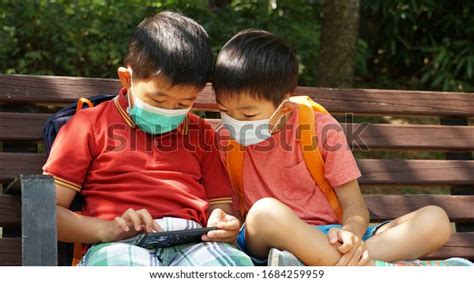 Two Asian Kids Playing Watching Mobile Stock Photo 1684259959