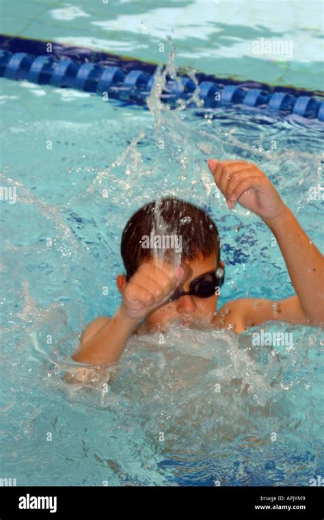 Young Boy Splashing In A Swimming Pool Stock Photo Alamy
