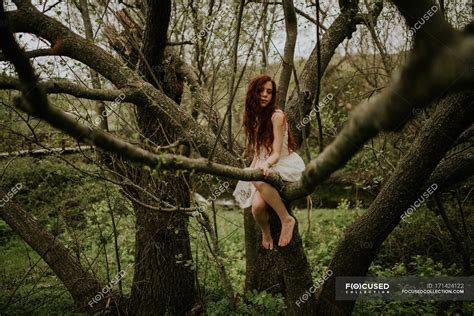 Ginger Girl Posing On Bending Over Ground Tree Branch — Portrait
