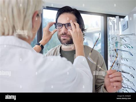 Optometrist Glasses And Man In Store For Choice Of Frames Eyesight And Vision Customer Face