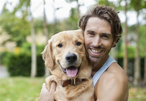Smiling Man Petting Dog Outdoors Stock Image F0137520 Science