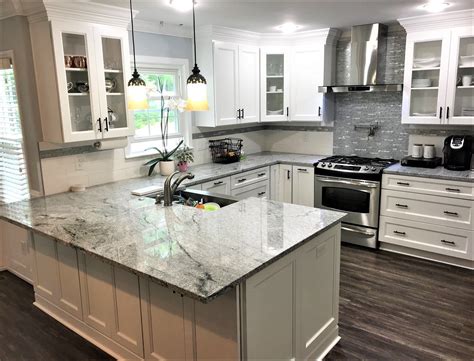 Surmounted by granite tops, the cabinets adds class and style. Viscon White Granite, White Cabinets, Dark Hardwood Floors ...