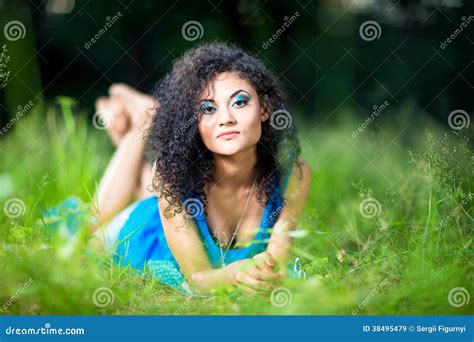 Young Relaxing Female Lying On Her Stomach In The Grass Stock Image 38495479