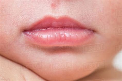 Close Up Macro Of Newborn Baby Lips With Tiny Bubbles Stock Photo